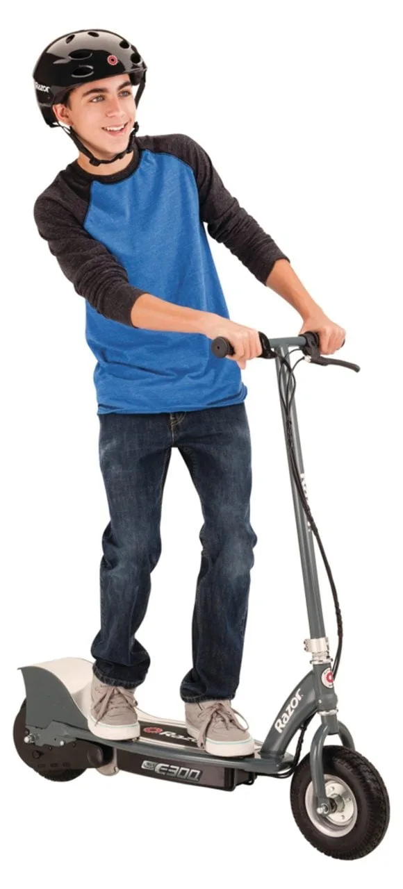 Teen rider wearing a black helmet riding the Razor E300 electric scooter in matte grey, showing the wide deck and full scooter profile