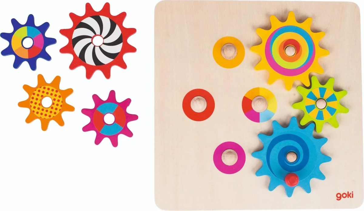 The Goki Cogwheel Game wooden puzzle board with colourful spinning gears placed on it, and the loose gear pieces shown to the side.