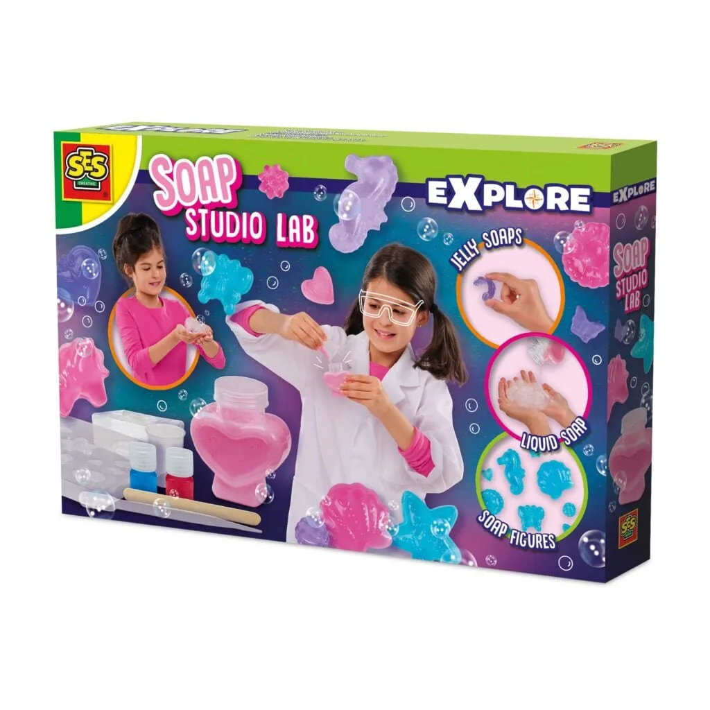 A girl in a lab coat experiments with the SES Creative Explore Soap Studio Lab, showing the various moulds and types of soap that can be made.