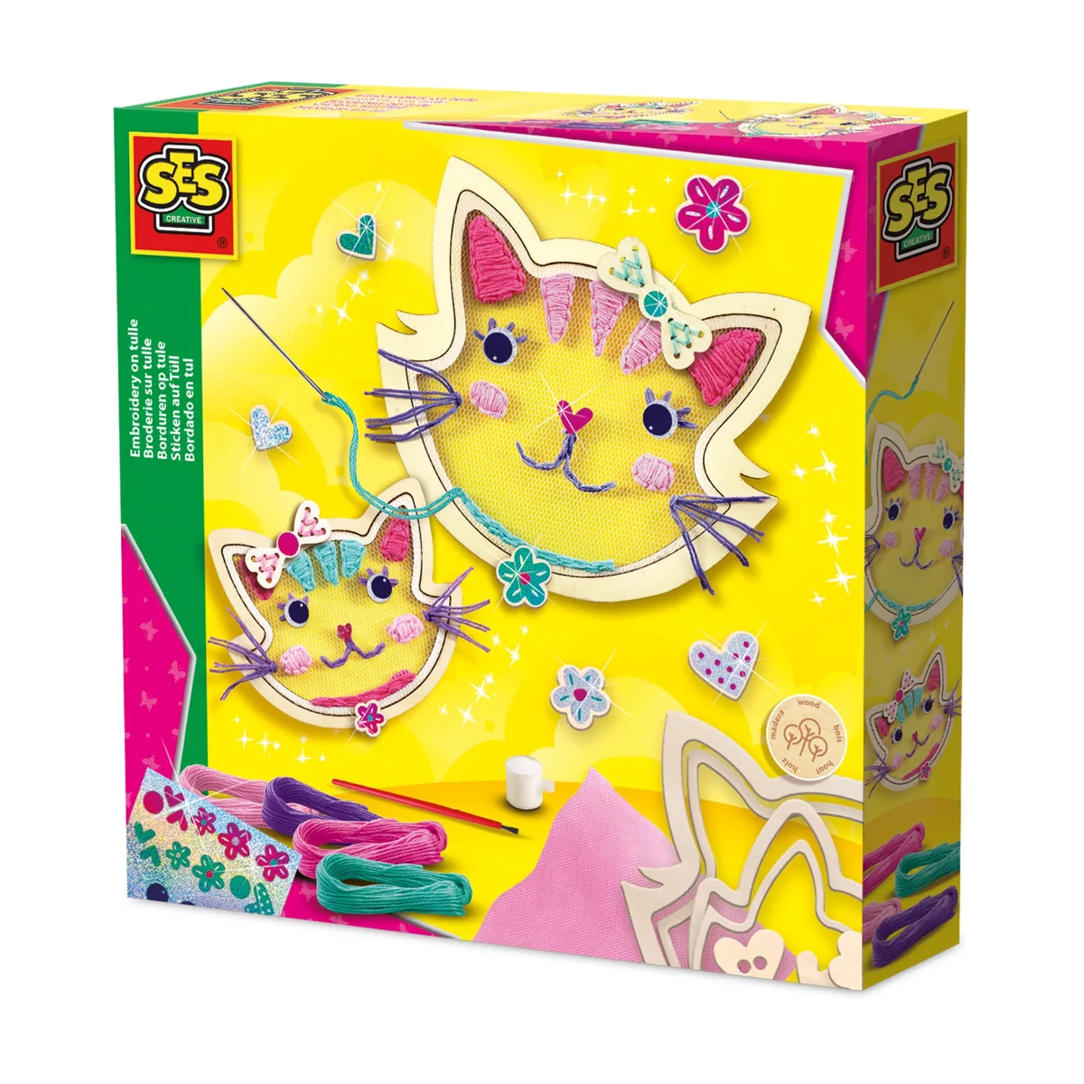A girl holding a finished cat-shaped tulle embroidery craft made with the SES Creative kit.