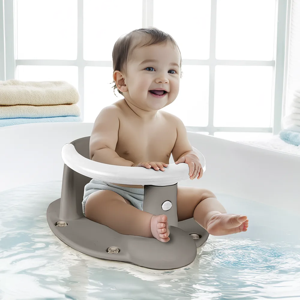 Smiling baby sitting upright in the Dolu stone grey bath seat inside a white bathtub, showing in-use scale