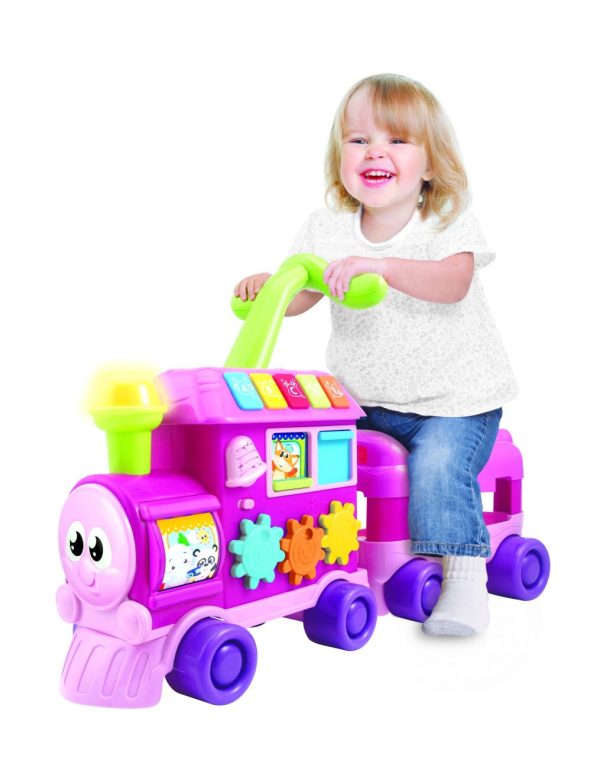 Young girl riding on the Walker Ride-On Learning Train (Pink)