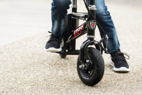 Razor E-Punk 12 Volt - Ages 8+ years - close up on wheels, young buy riding bike outdoors.