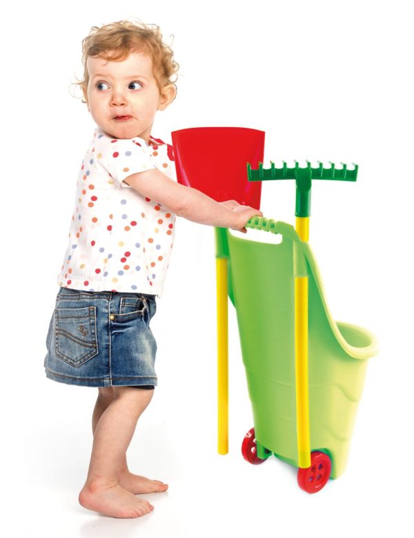 Toy Garden Trolley with Toy Garden Tools. Young girl playing with the tools.