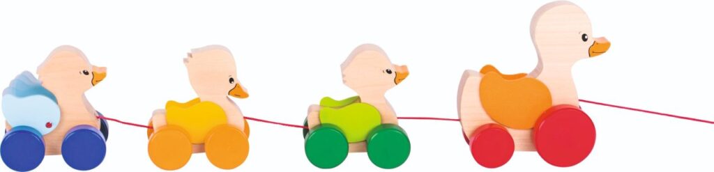 The Goki Pull-along Duck Family, a wooden toy with a mother duck and three colourful ducklings whose wings flap when pulled.