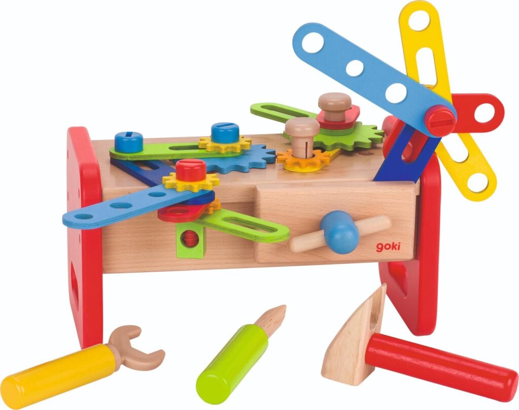 The Goki Construction Workbench, a wooden toy with colourful gears, nuts, and bolts, shown with its toy hammer, screwdriver, and spanner.