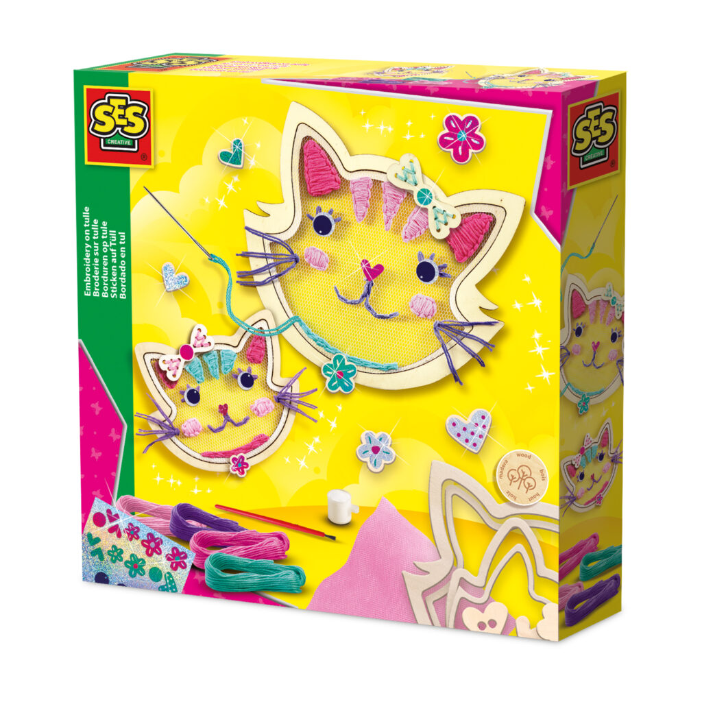 A girl holding a finished cat-shaped tulle embroidery craft made with the SES Creative kit.