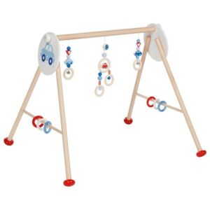 The Goki wooden baby gym with a car theme, showing the A-frame structure and the hanging wooden toys for sensory play.