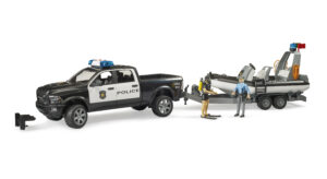 Black and white police pickup truck toy towing a trailer with a floatable police boat and two figures.