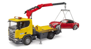 Yellow Scania tow truck toy lifting a red roadster car with its crane and loading harness.