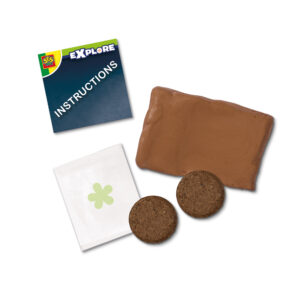 SES Creative Explore kit showing clay, coconut tablets, seeds, and instructions to make butterfly flower bombs.