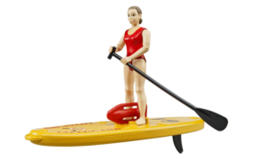 Female bworld lifeguard figure standing on a yellow floatable SUP board with a paddle and rescue buoy