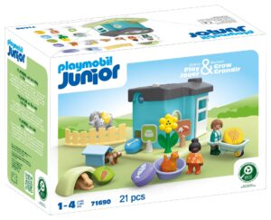 Playmobil JUNIOR Animal Home with Treat Dispenser featuring toddler figures, animals, and a bright blue play building.